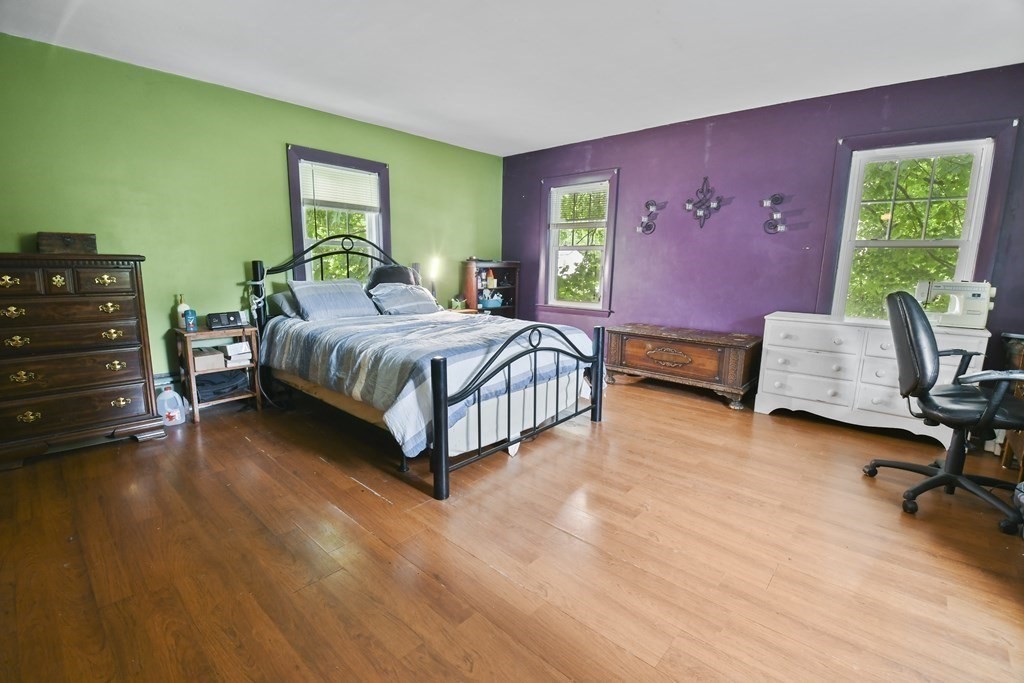 9 Dervin Place Clinton, MA 01510 - Photo 11 of 20 a spacious bedroom with a bed and a lounge chair