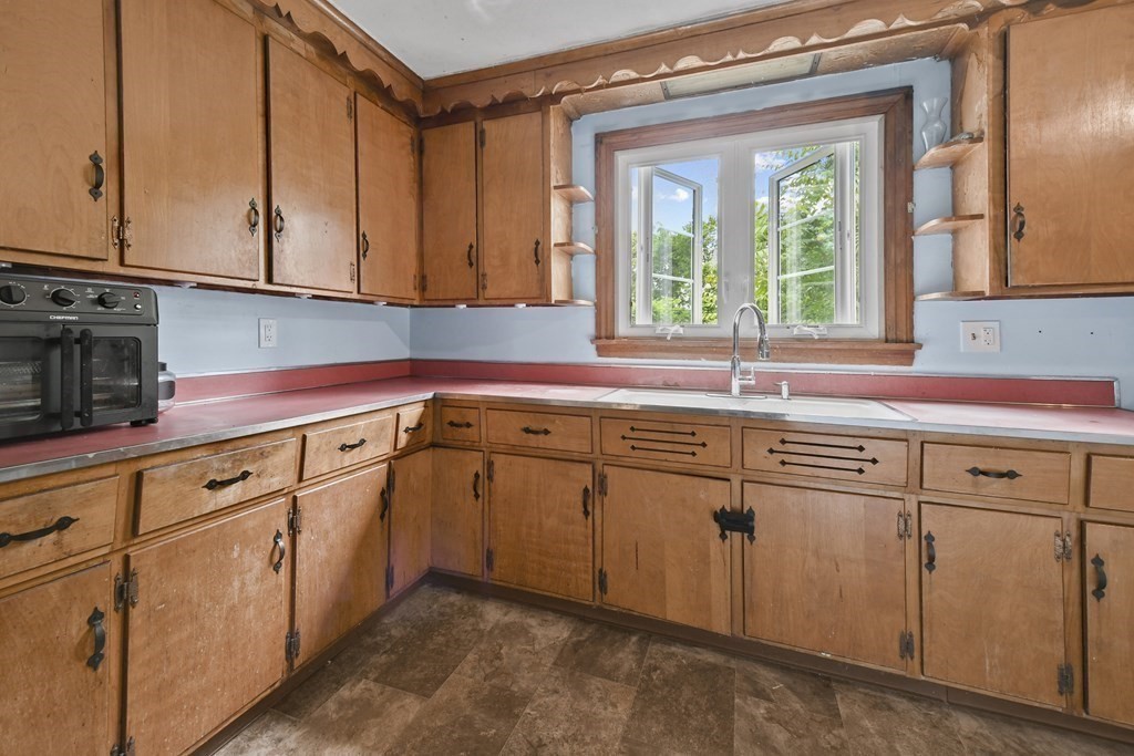 9 Dervin Place Clinton, MA 01510 - Photo 9 of 20 a kitchen with granite countertop cabinets sink and window