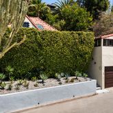 a aerial view of a house with a yard and potted plants
