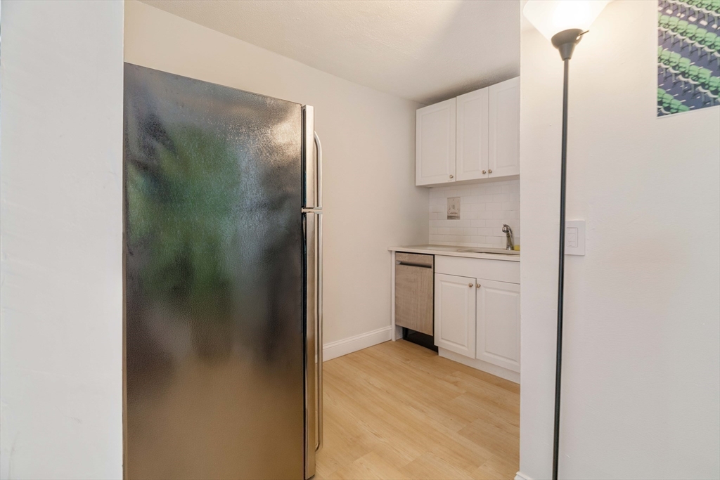 5 North Margin Street, Unit 9 Boston, MA 02113 - Photo 3 of 17 a kitchen with white cabinets and a sink