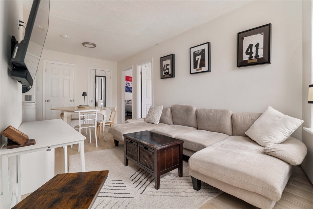 5 North Margin Street, Unit 9 Boston, MA 02113 - Photo 6 of 17 a living room with furniture and a flat screen tv