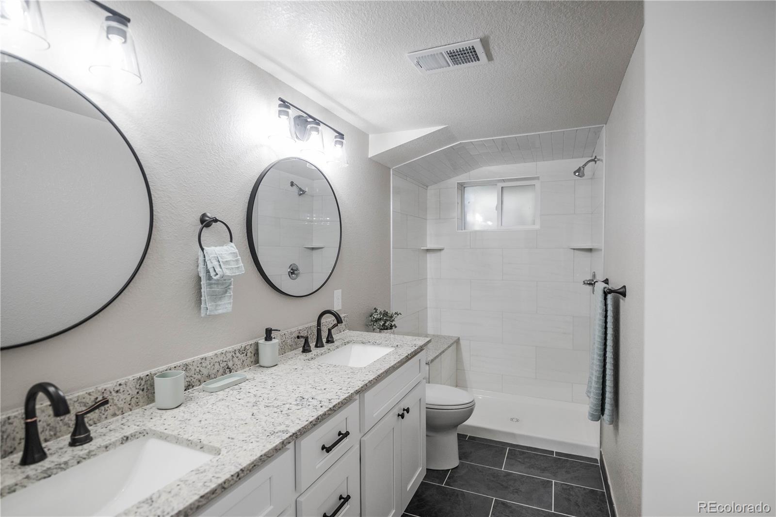 820 Drake Street Denver, CO 80221 - Photo 26 of 48 a bathroom with a granite countertop sink mirror and toilet