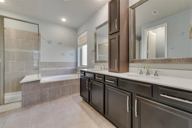 a bathroom with a bathtub sink and mirror