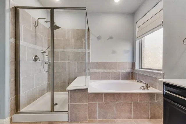 a bathroom with a bathtub and shower