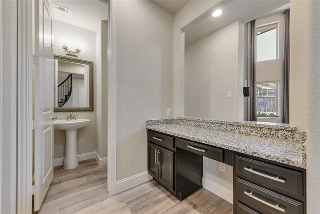 a view of cabinets and wooden floor