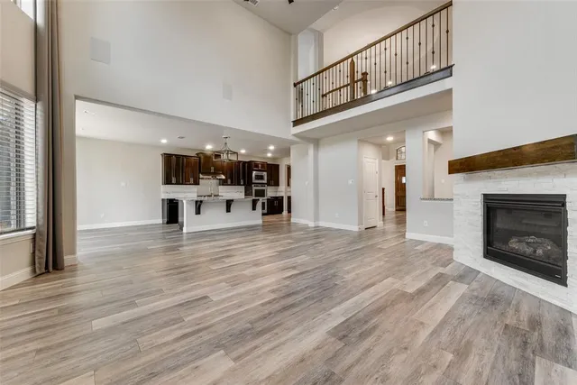 a view of a livingroom with a kitchen and a fireplace