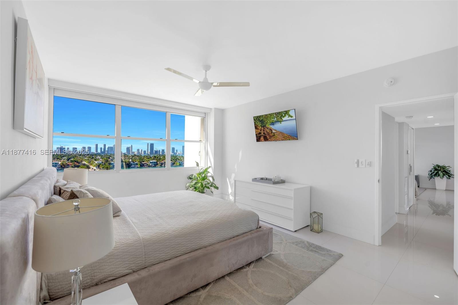 3 Island Avenue, Unit 10D Miami Beach, FL 33139 - Photo 11 of 23 a bedroom with a bed and a view of kitchen
