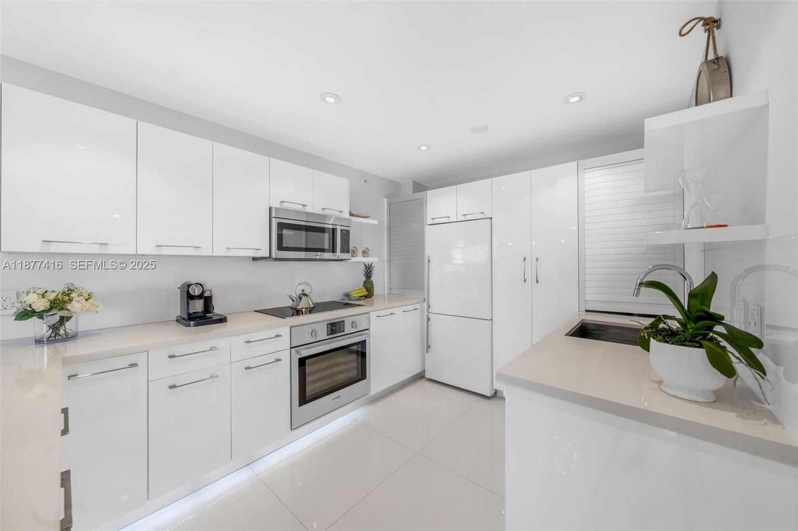 3 Island Avenue, Unit 10D Miami Beach, FL 33139 - Photo 7 of 23 a kitchen with white cabinets and appliances