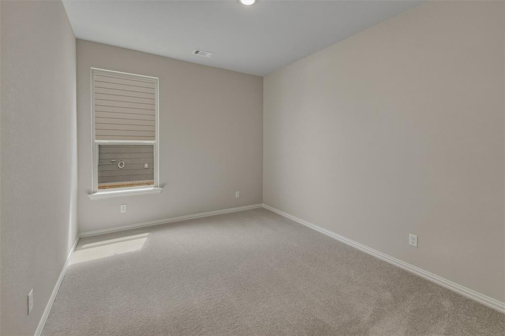 1232 Colca Drive Springtown, TX 76082 - Photo 9 of 23 Carpeted room with neutral paint, a single window featuring horizontal blinds, and white trim molding