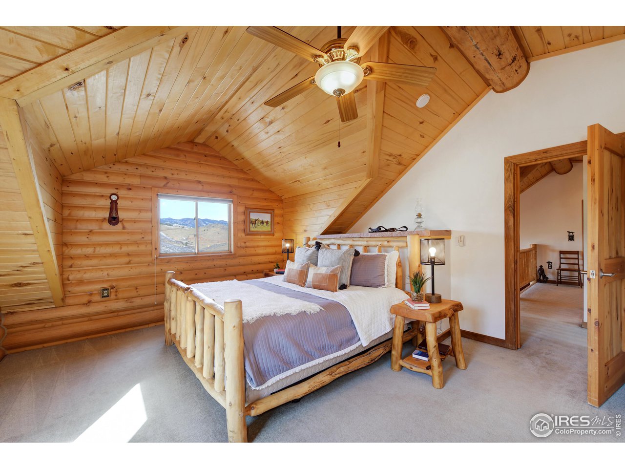 370 Blue Mountain Trail Lyons, CO 80540 - Photo 14 of 37 a bedroom with a bed and a table