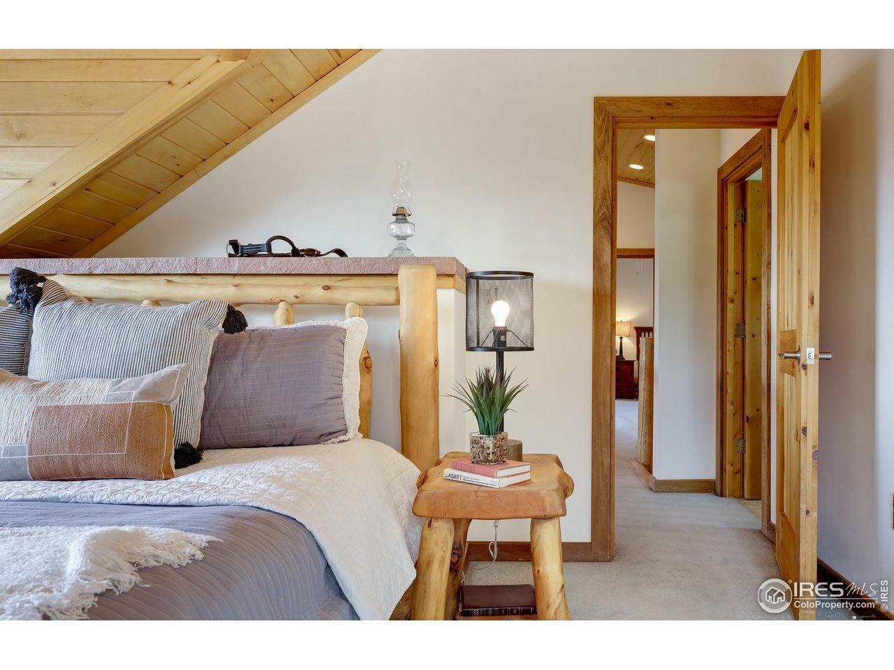 370 Blue Mountain Trail Lyons, CO 80540 - Photo 15 of 37 a bedroom with a bed and a mirror