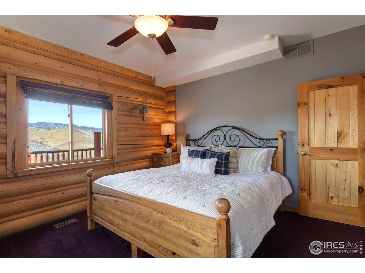 370 Blue Mountain Trail Lyons, CO 80540 - Photo 16 of 37 a bedroom with a bed and a window