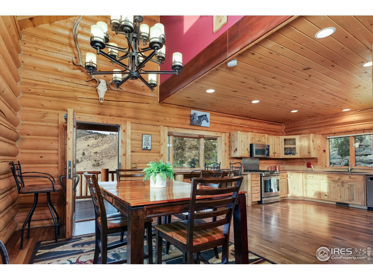 370 Blue Mountain Trail Lyons, CO 80540 - Photo 9 of 37 a view of a dining room with furniture and wooden floor