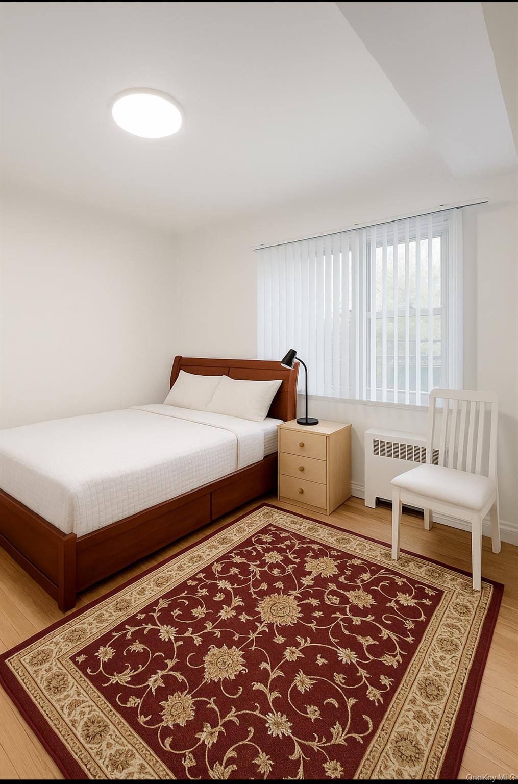 932 Adee Avenue Bronx, NY 10469 - Photo 3 of 9 a bedroom with a bed and a window