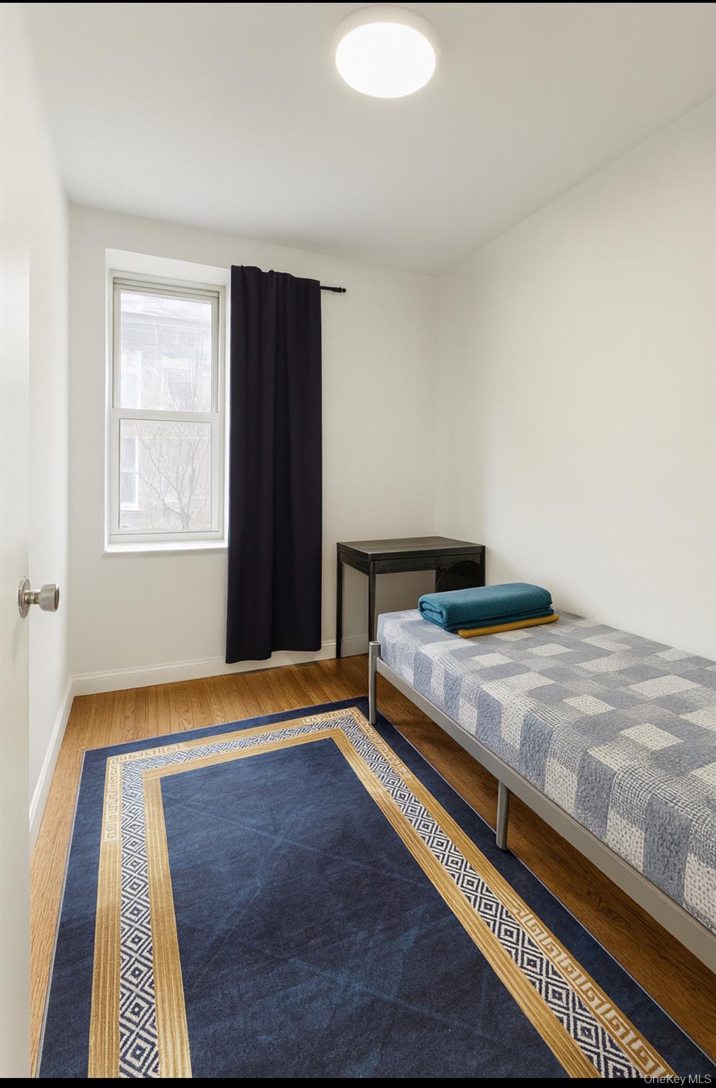 932 Adee Avenue Bronx, NY 10469 - Photo 4 of 9 a bedroom with a bed and a window