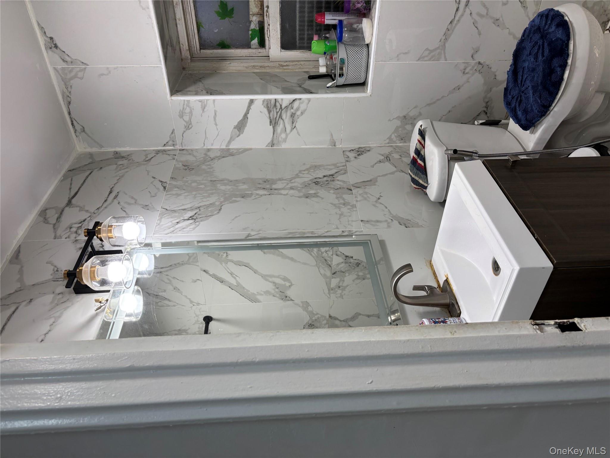 932 Adee Avenue Bronx, NY 10469 - Photo 9 of 9 a bathroom with a sink a toilet a mirror and shower