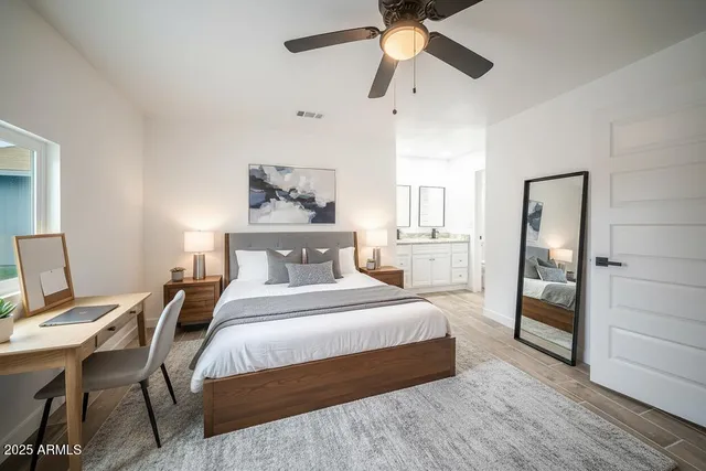 a bedroom with a bed and a chandelier