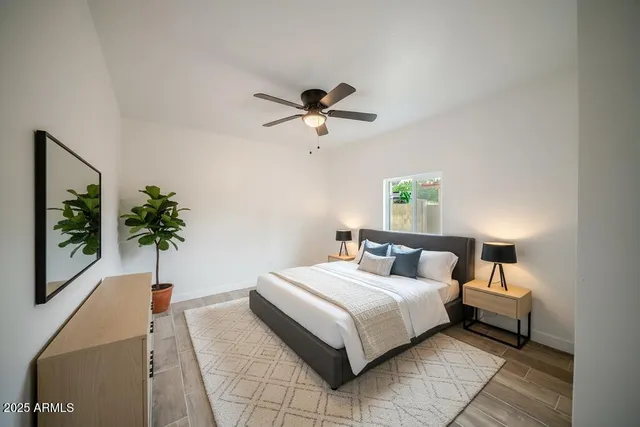 a bedroom with a bed and a potted plant