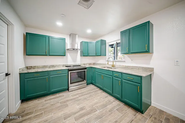 a kitchen with stainless steel appliances kitchen island granite countertop a sink and a stove