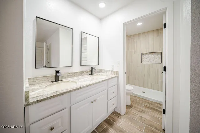 a bathroom with a granite countertop sink mirror and double