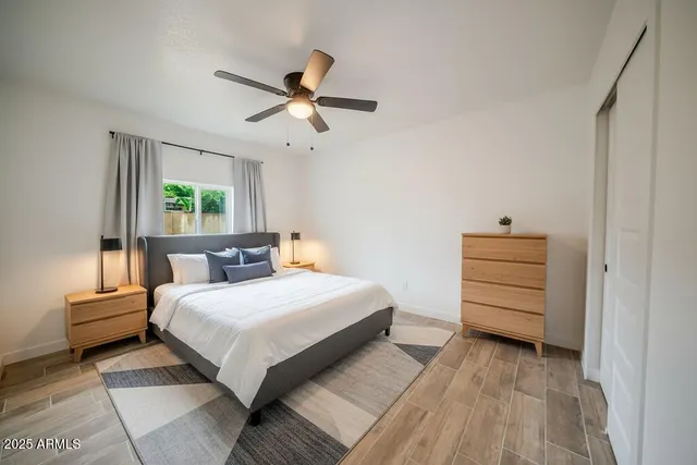 a bedroom with a bed a dresser and a window