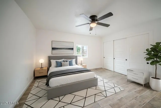 a bedroom with a bed and a potted plant