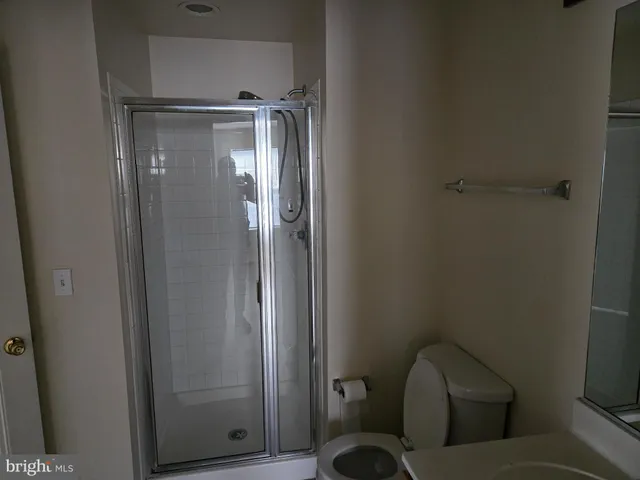 a bathroom with a toilet and shower