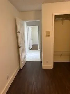 an empty room with wooden floor and a fireplace