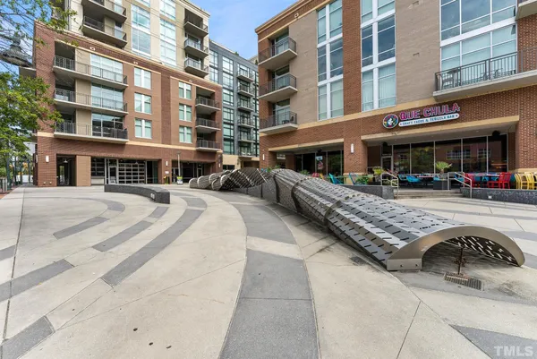 a front view of building with cars parked