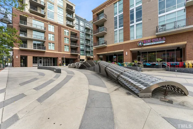 a front view of building with cars parked