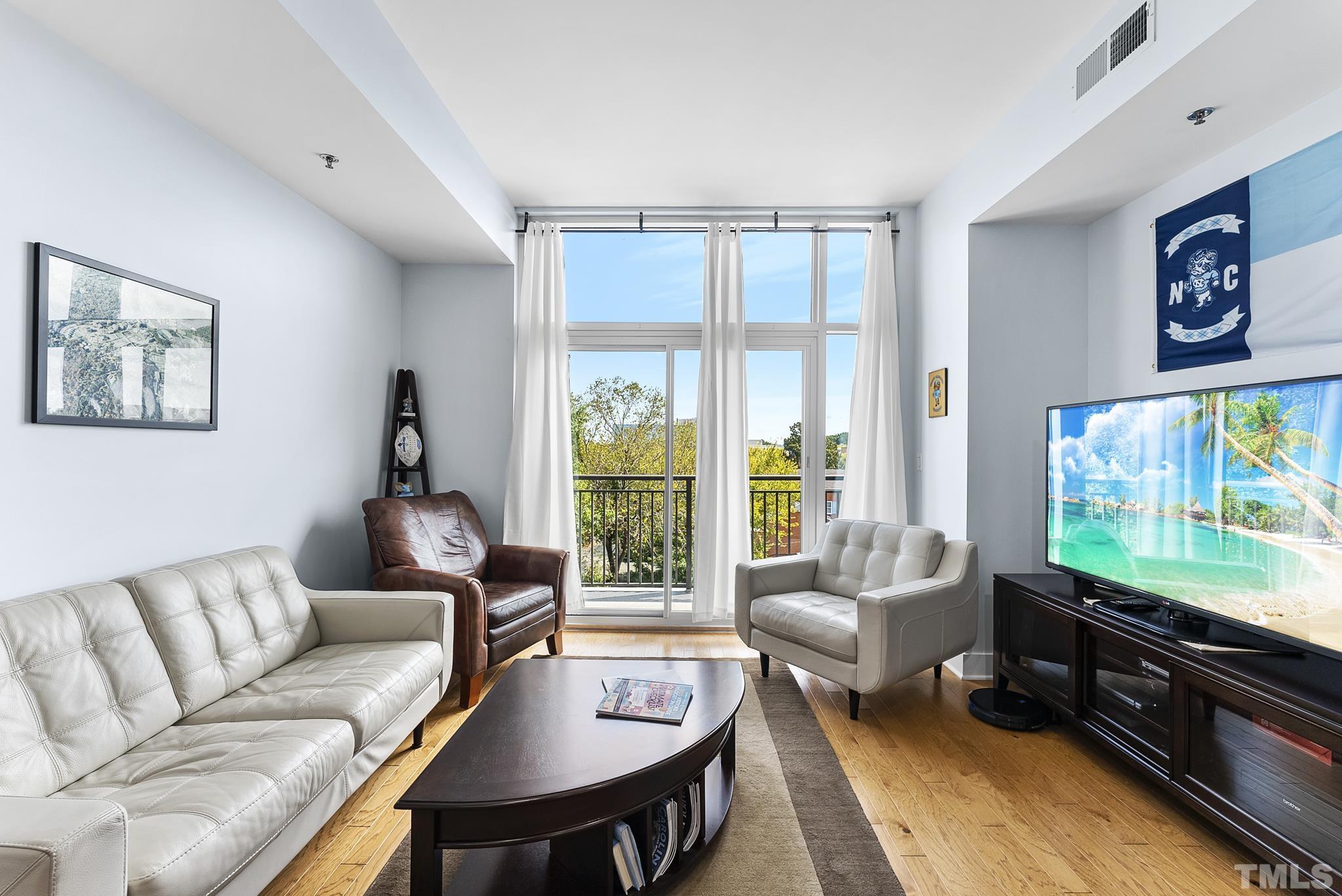 140 West Franklin Street, Unit 415 Chapel Hill, NC 27516 - Photo 11 of 29 a living room with furniture and a flat screen tv