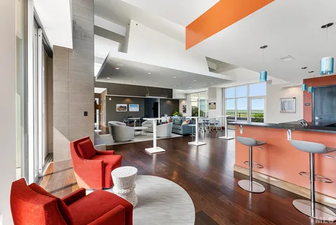 a living room with fireplace furniture and a large window