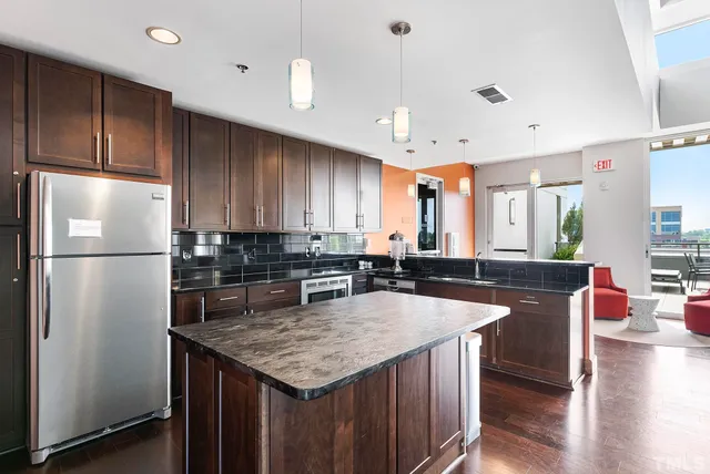 a kitchen with granite countertop a sink appliances and cabinets