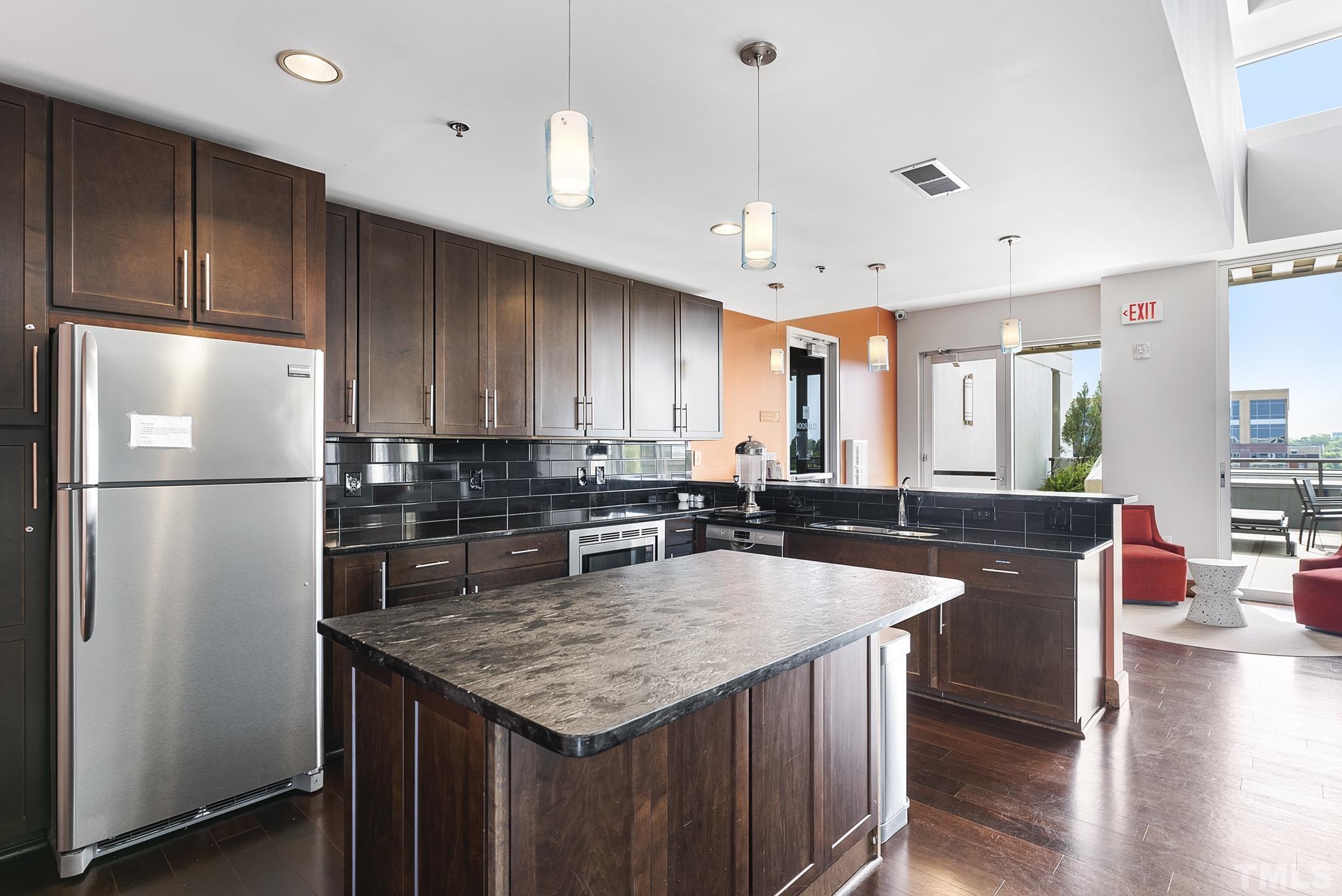 140 West Franklin Street, Unit 415 Chapel Hill, NC 27516 - Photo 19 of 29 a kitchen with granite countertop a sink appliances and cabinets