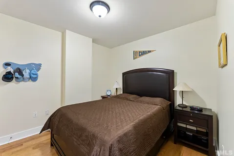 a bedroom with a bed and a wall painting