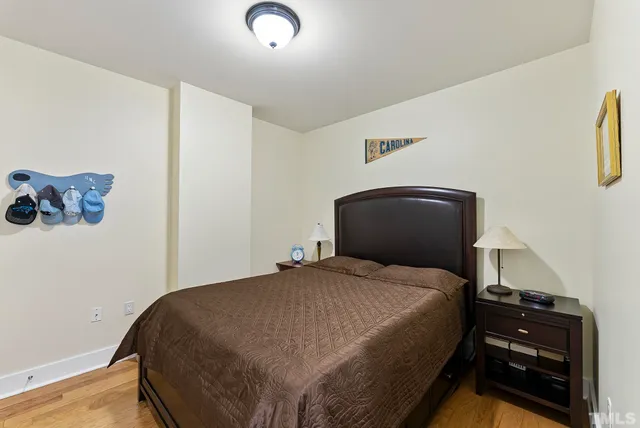 a bedroom with a bed and a wall painting