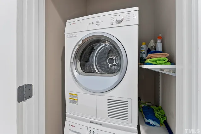 a close view of a utility room with dryer and washer