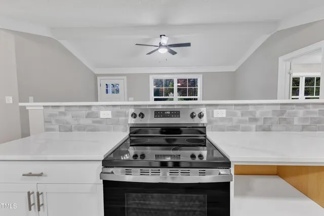 a stove top oven sitting inside of a kitchen