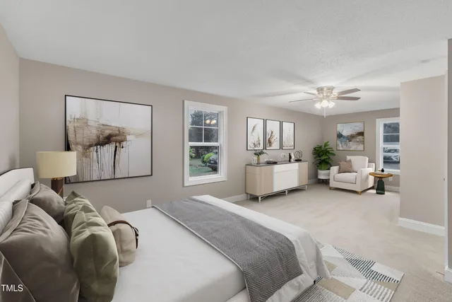 a spacious bedroom with a bed and furniture