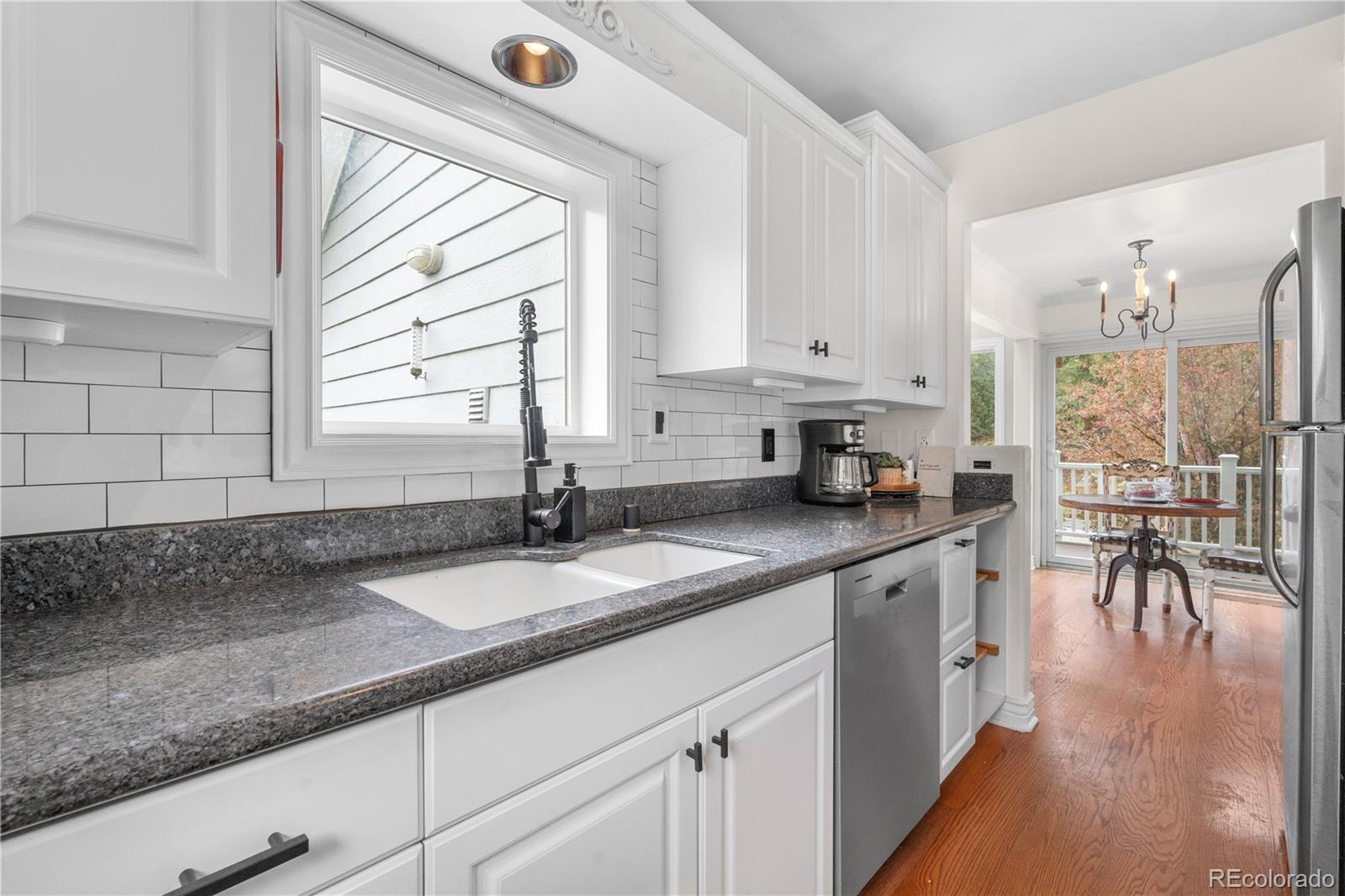 137 Bob Cat Trail Bailey, CO 80421 - Photo 12 of 46 a kitchen with granite countertop a sink a counter top space and cabinets