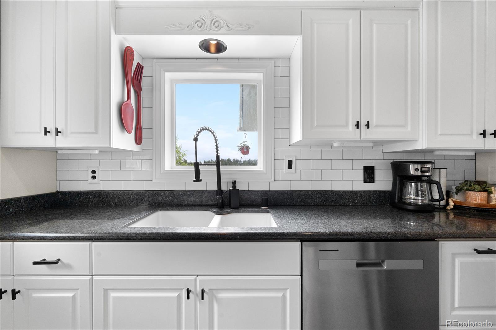 137 Bob Cat Trail Bailey, CO 80421 - Photo 14 of 46 a kitchen with granite countertop white cabinets and sink