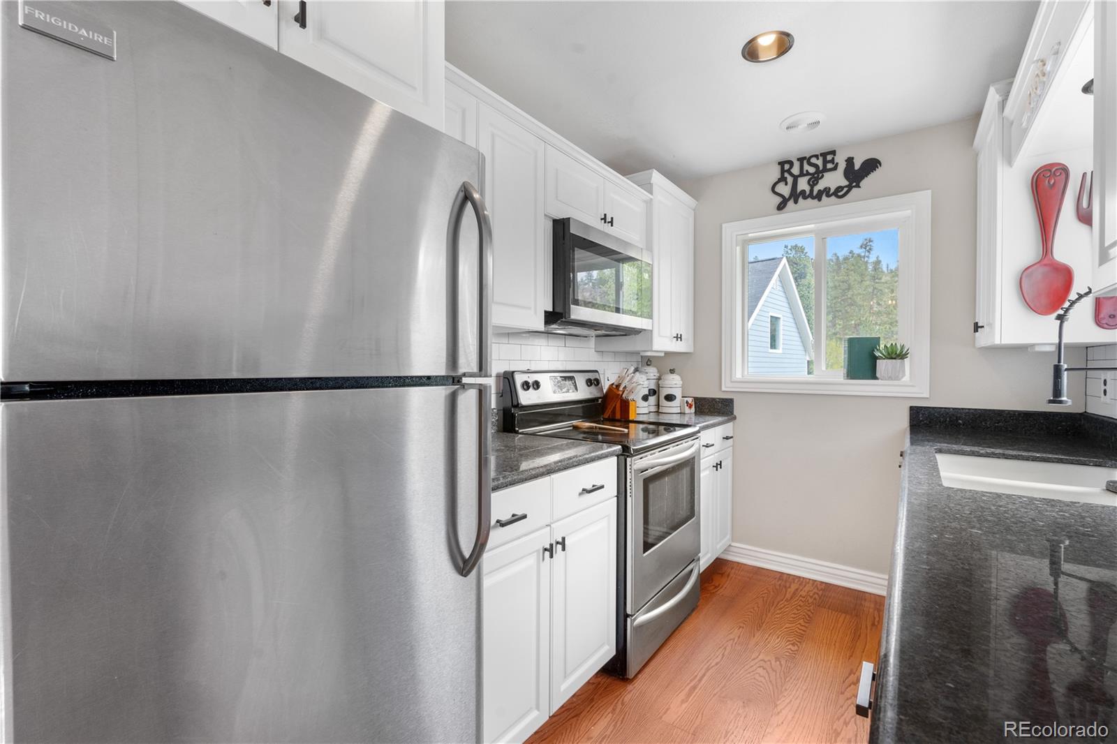 137 Bob Cat Trail Bailey, CO 80421 - Photo 15 of 46 a kitchen with stainless steel appliances granite countertop a refrigerator and a stove