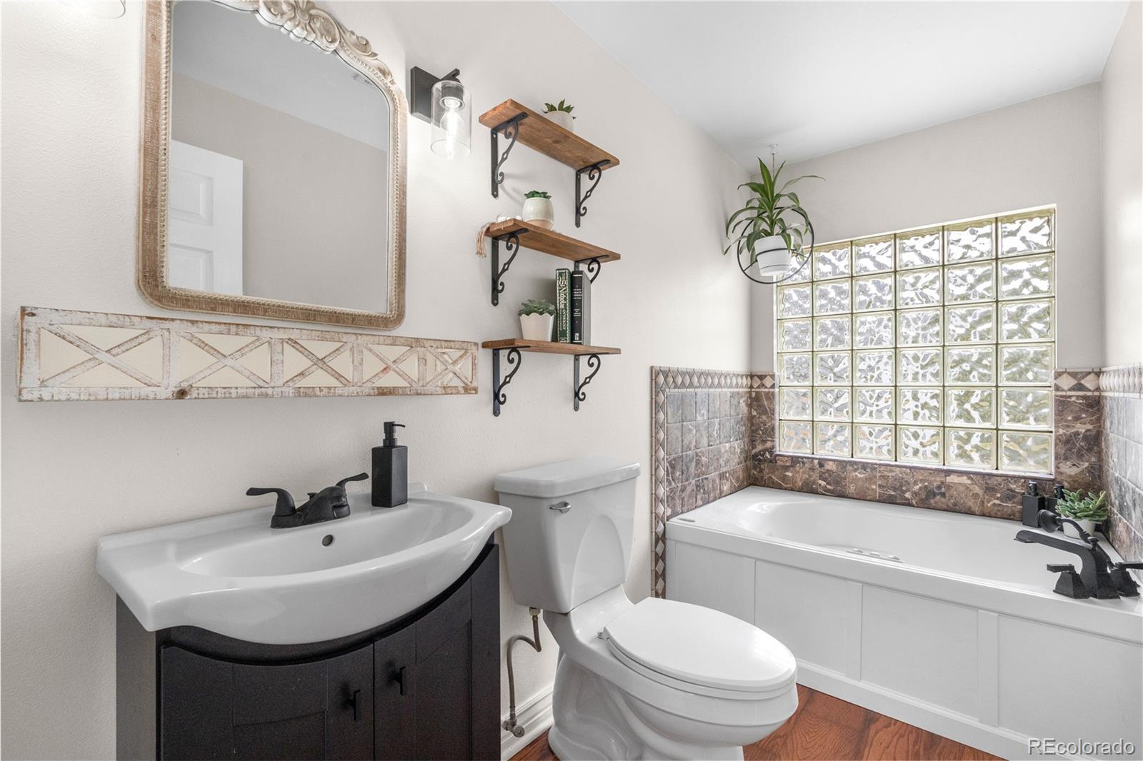 137 Bob Cat Trail Bailey, CO 80421 - Photo 16 of 46 a bathroom with a sink toilet a mirror and shower