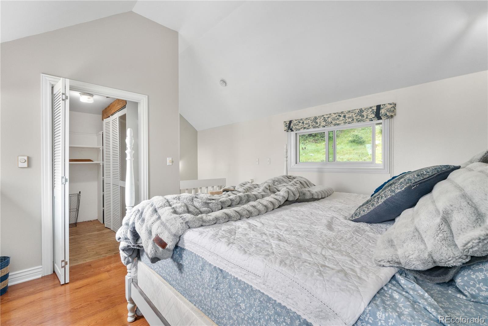 137 Bob Cat Trail Bailey, CO 80421 - Photo 19 of 46 a bedroom with a bed and a window
