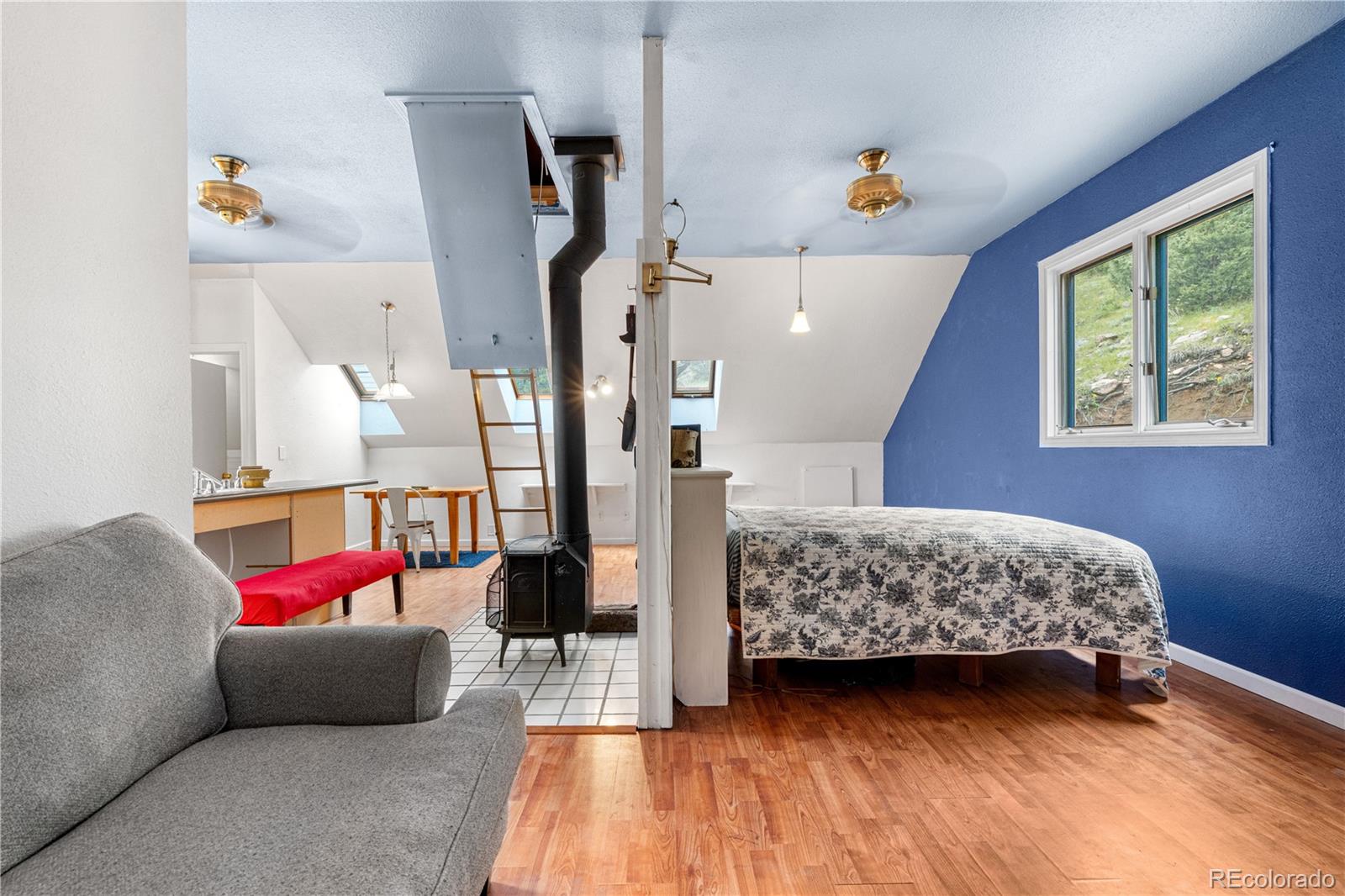 137 Bob Cat Trail Bailey, CO 80421 - Photo 28 of 46 a living room with furniture and wooden floor