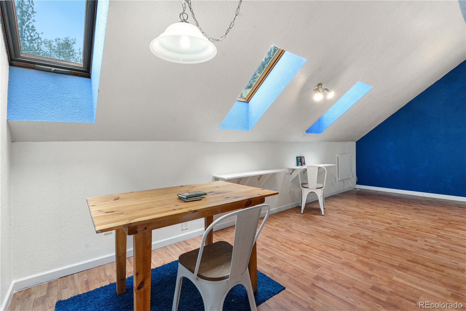 137 Bob Cat Trail Bailey, CO 80421 - Photo 29 of 46 a view of a dining room with furniture and wooden floor