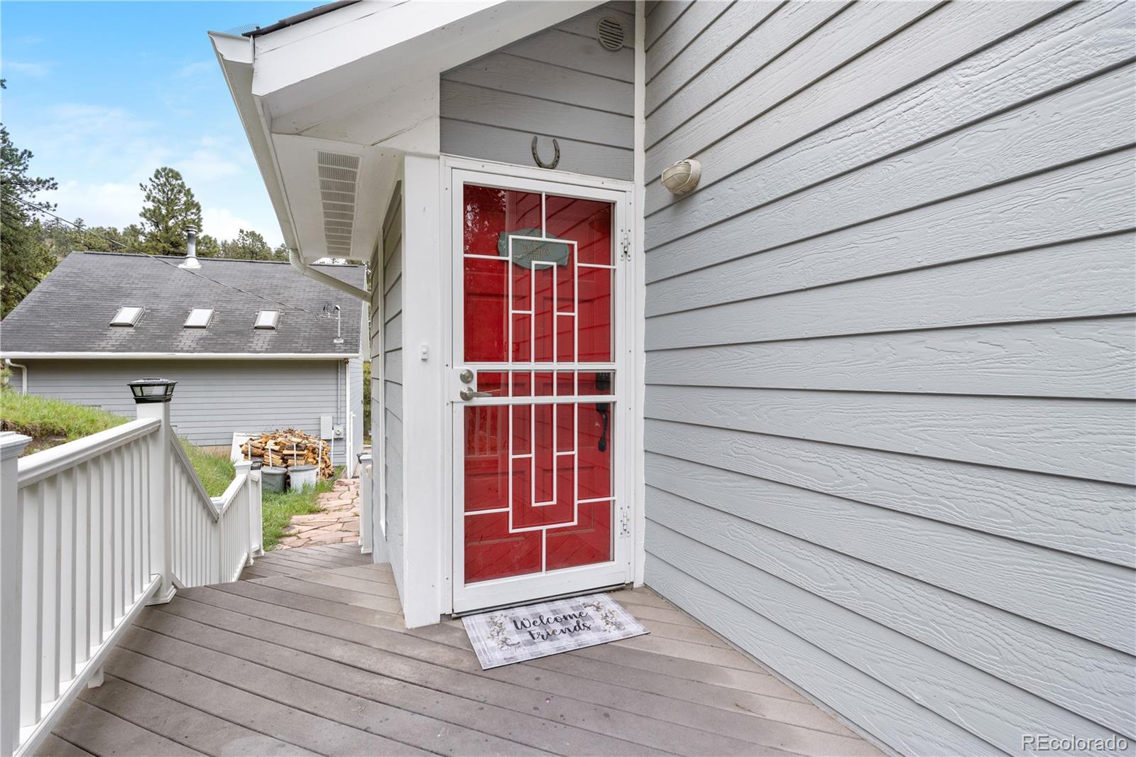 137 Bob Cat Trail Bailey, CO 80421 - Photo 35 of 46 a front view of a house with glass door
