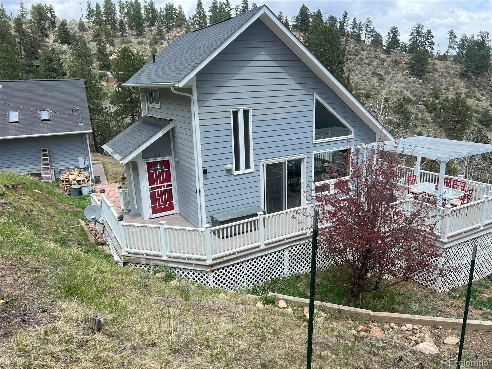 137 Bob Cat Trail Bailey, CO 80421 - Photo 37 of 46 a view of a white house next to a yard