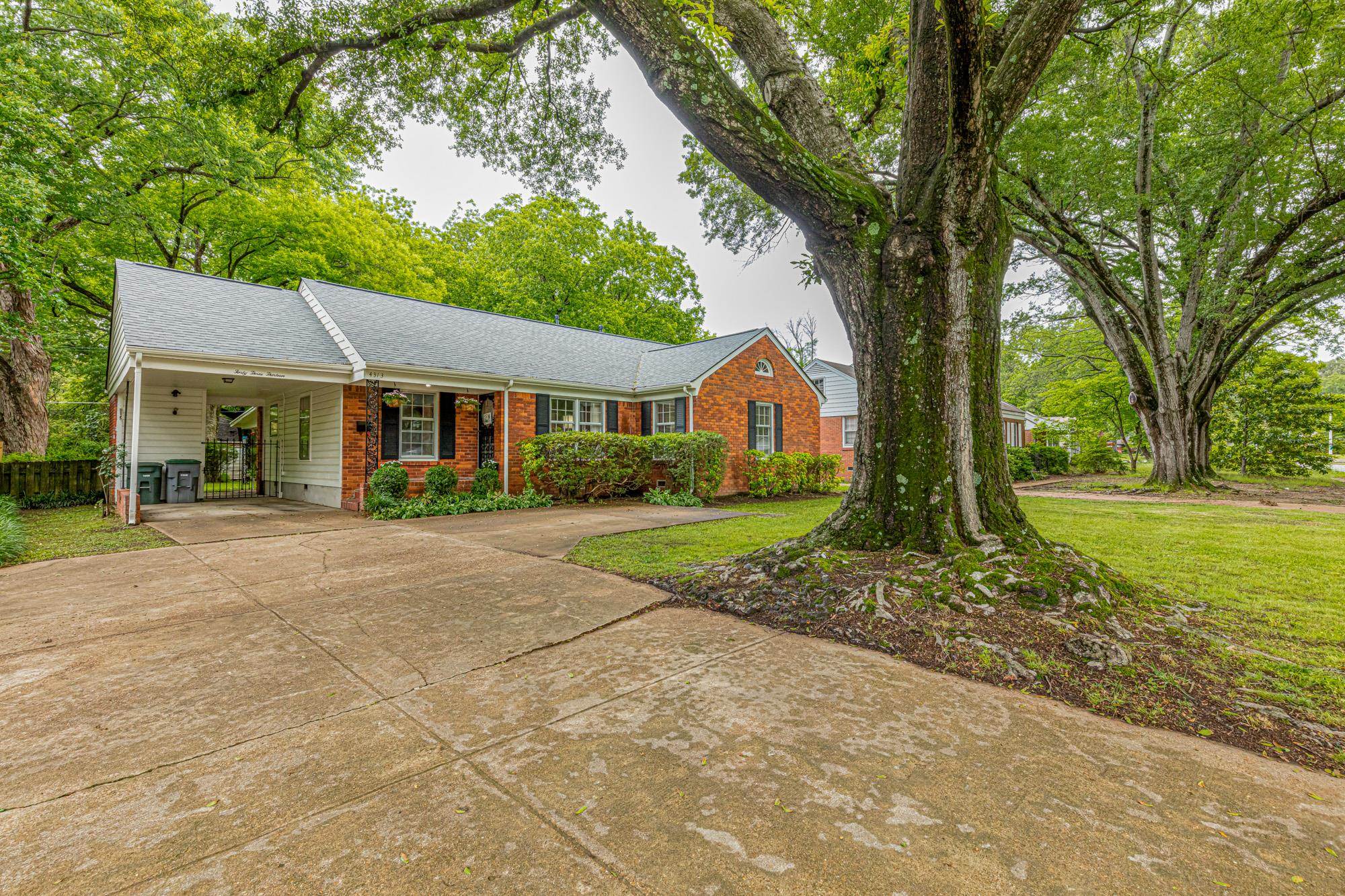 4313 Rhodes Avenue Memphis, TN 38111 - Photo 4 of 25 a front view of a house with a yard