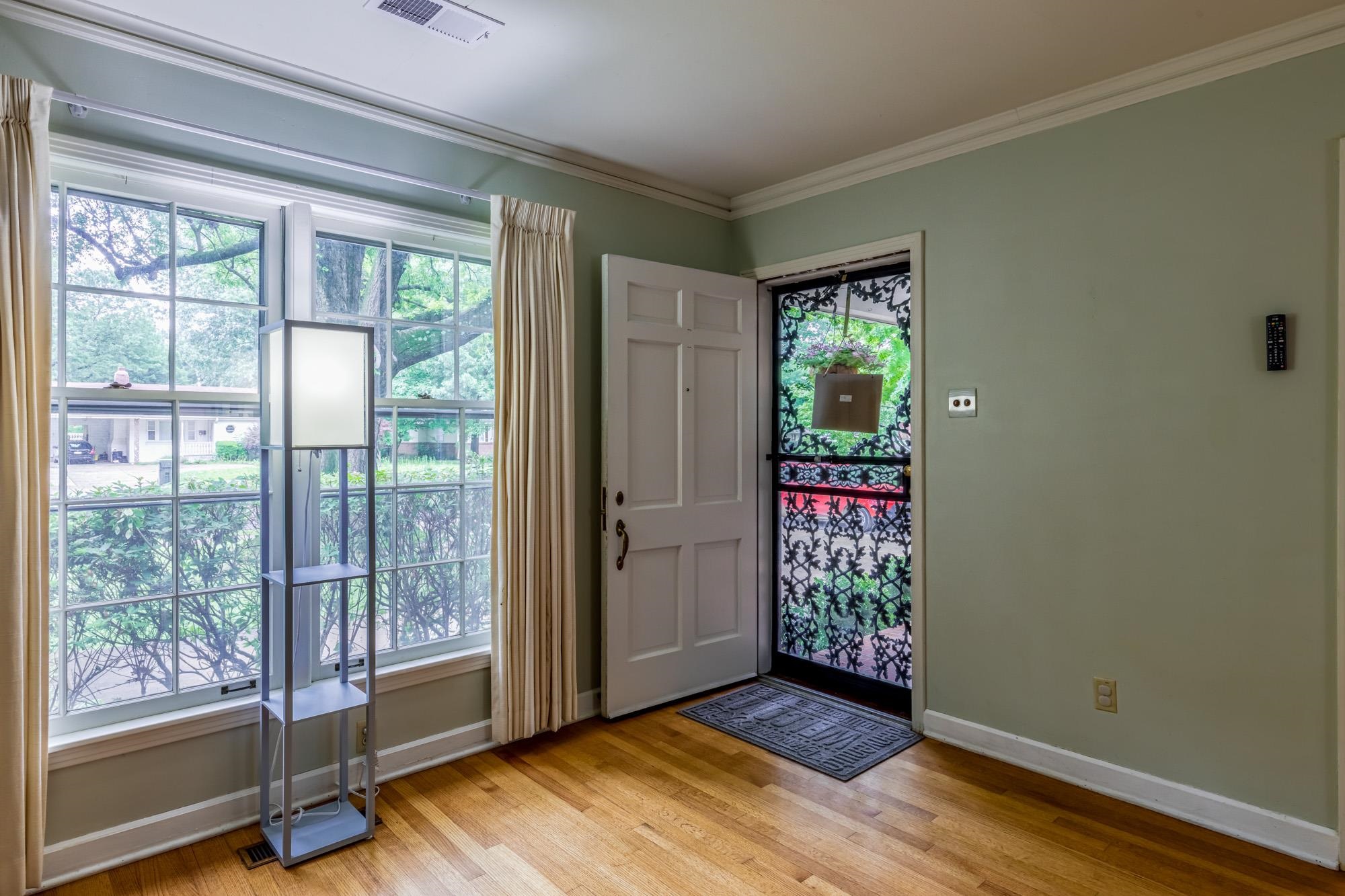 4313 Rhodes Avenue Memphis, TN 38111 - Photo 6 of 25 a view of an empty room with wooden floor and doors